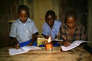 Children reading with kerosene lamp.jpg