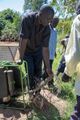 Members of Tuinuane Kenya CBO prepare their solar powered water pump to begin irrigating their fields in Ndivisi, Bungoma county.