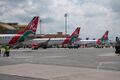 A wide angle view of various Kenya Airways airplanes at the JKIA Terminal One