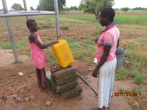 Inhabitants of the Nabio community fetching water from the standpipe.JPG