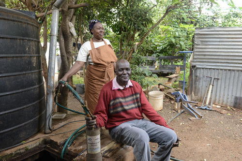 Water Tank in Kenya with man and woman.jpg